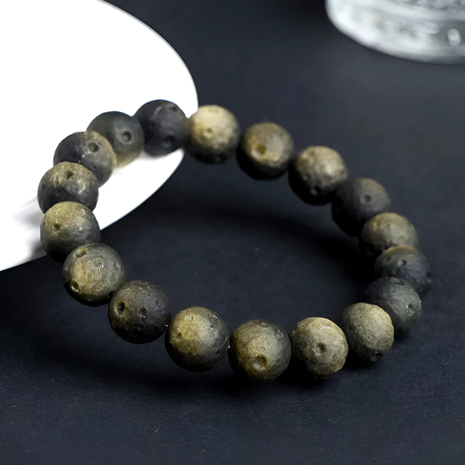 Natural obsidian crater ball bracelet with polished beads in silver or golden meteorite colours