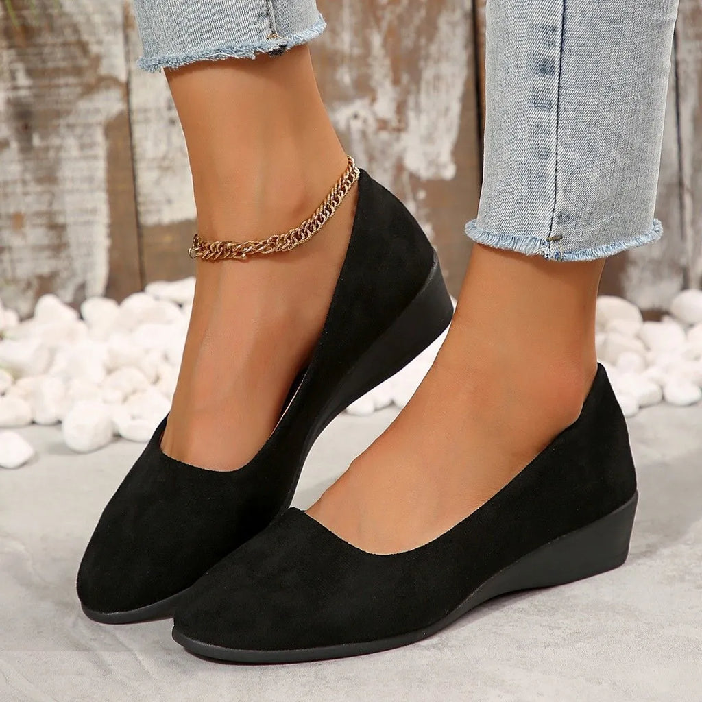 Women's suede wedge pump shoes in light brown with a low rubber sole and rounded toe.