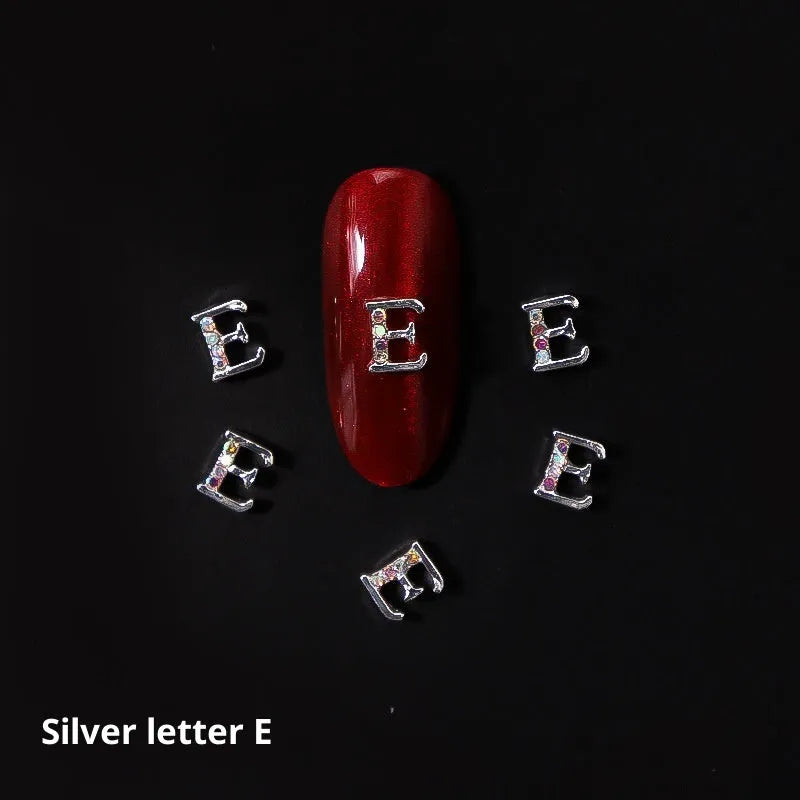 Gold alloy letter A nail ornament charm with crystal detail on a square chain base
