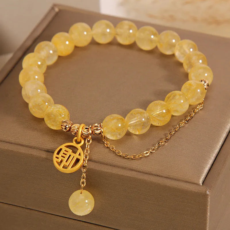 Natural citrine stone bracelet with an electroplated Chinese character tassel charm.