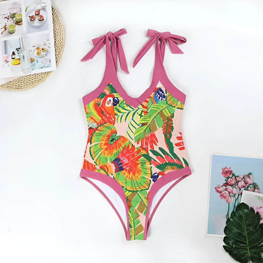 Women's pink floral print one-piece swimsuit with v-neck, covered belly, and attached thin skirt.