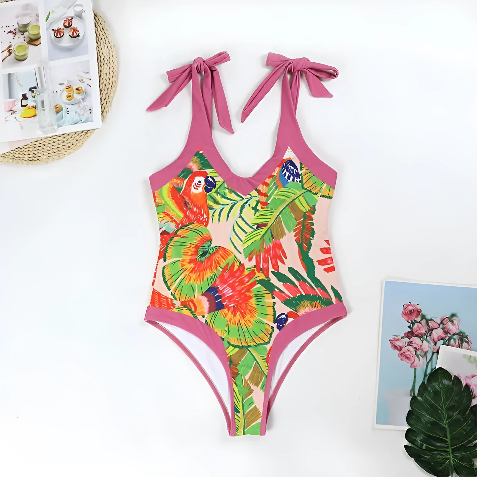 Women's pink floral print one-piece swimsuit with v-neck, covered belly, and attached thin skirt.