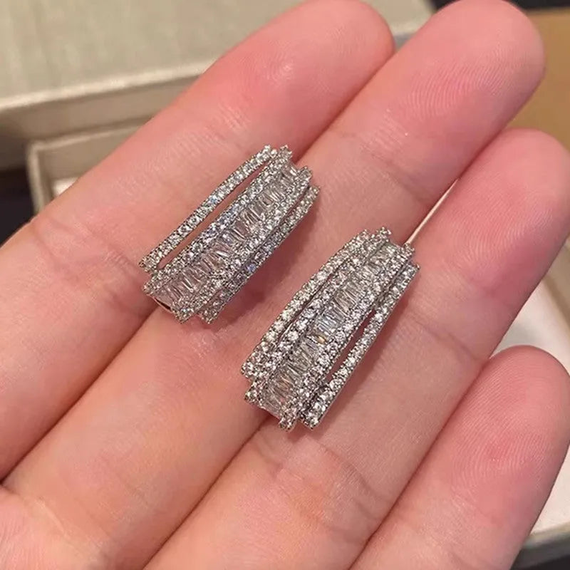 Geometric stud earrings with inlaid zircon stones in white gold colour