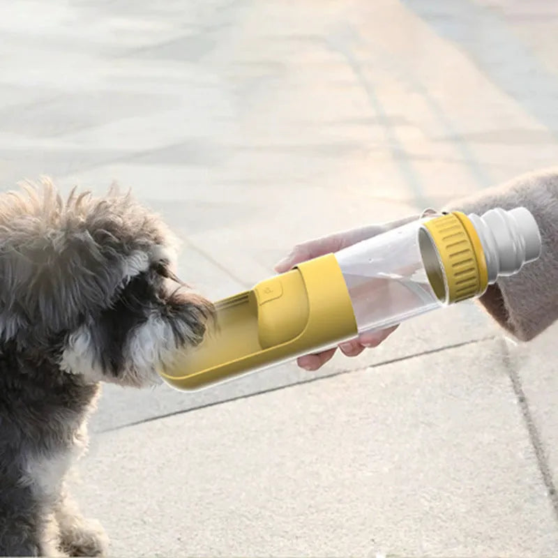 Dark blue portable dog water bottle with flip-out bowl, shown with leash.
