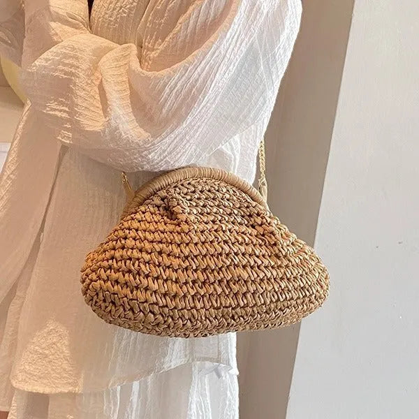 Women's khaki paper straw shoulder bag with chain strap and shell shape showing internal zippered compartment