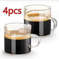 Two white transparent double mouth coffee glasses on a table.
