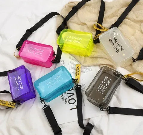Clear square jelly shoulder bag with adjustable strap in various colours on a white background.