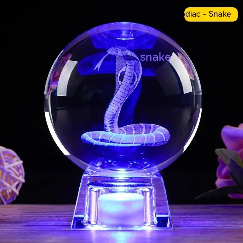 White crystal zodiac decorative ball with electronic base lighting showing Chinese-style animal design