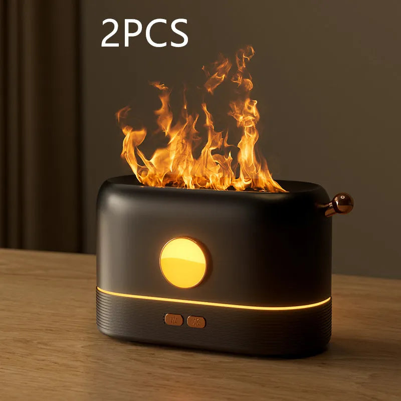 Black USB desktop humidifier with decorative orange flame effect and water tank on a wooden desk.