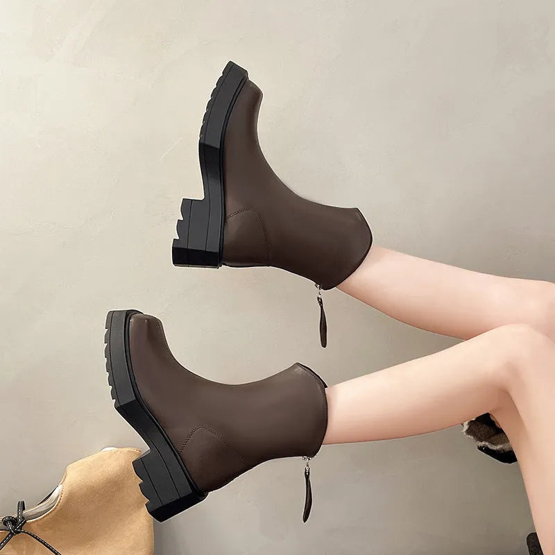 Black women's platform Martin boots with square toe and back zipper, showing mid-calf height.