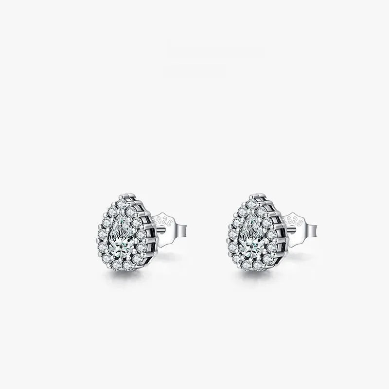 A pair of silver water drop shaped stud earrings with a diamond-cut faceted surface.