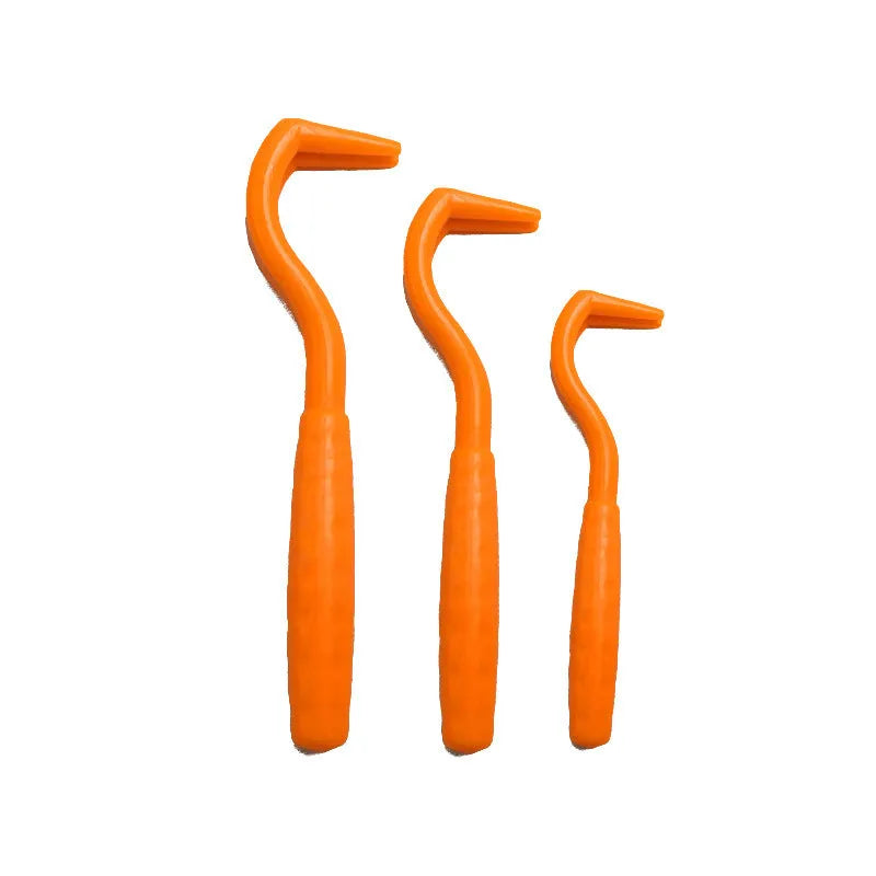 Three plastic tick removal hooks for dogs in assorted colours on a white background.