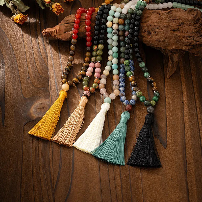 Vintage bohemian long necklace with geometric stone beads and tassel, shown with a matching shorter bracelet.