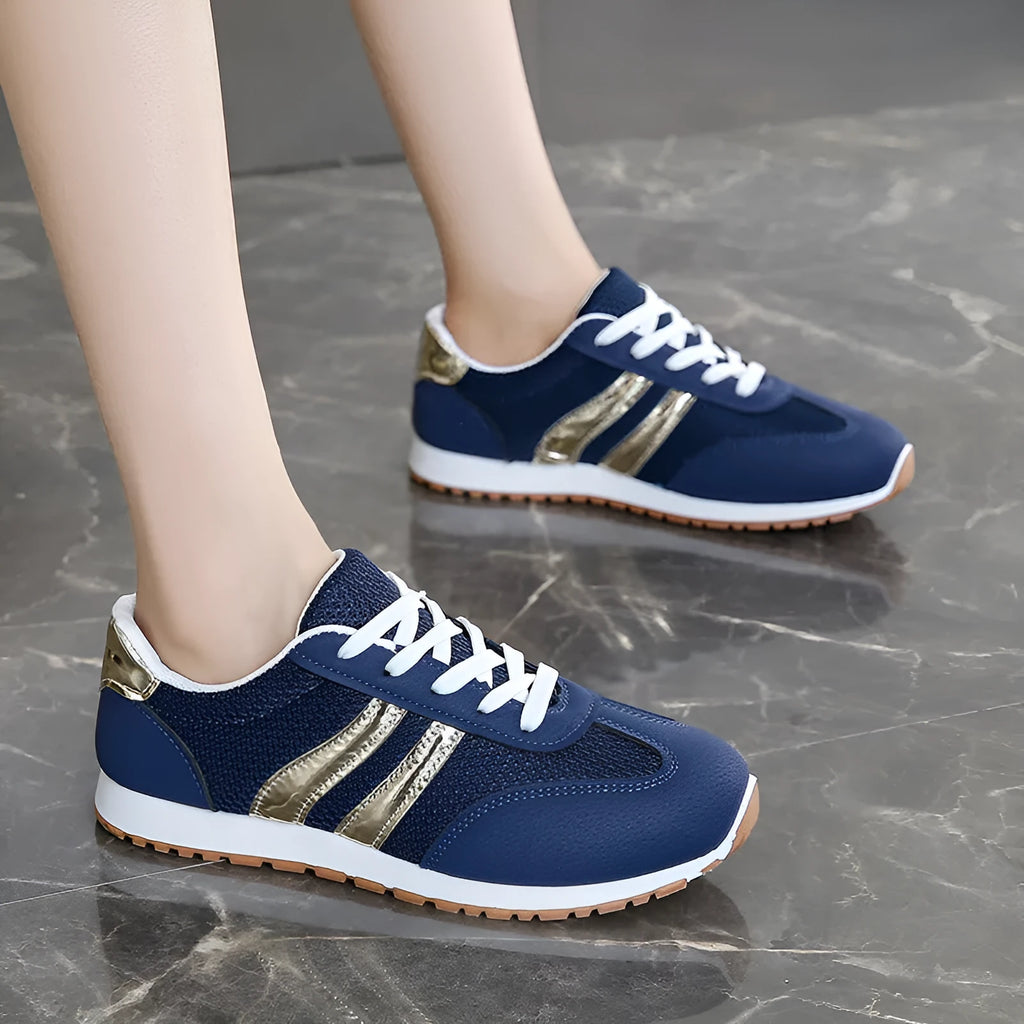 Blue women's casual sports shoes with cross shoulder straps and white rubber sole, shown on a size label.