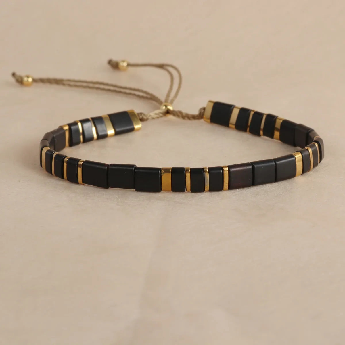 Geometric pull bead bracelet in milky white glass beads on a wrist.