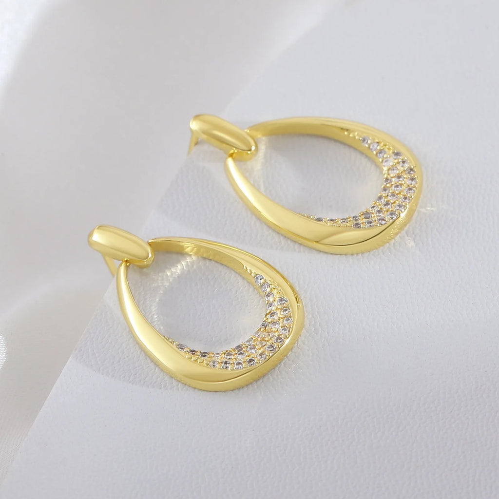 Yellow gold geometric drop earrings with zircon detailing on copper base, measuring 2.6cm