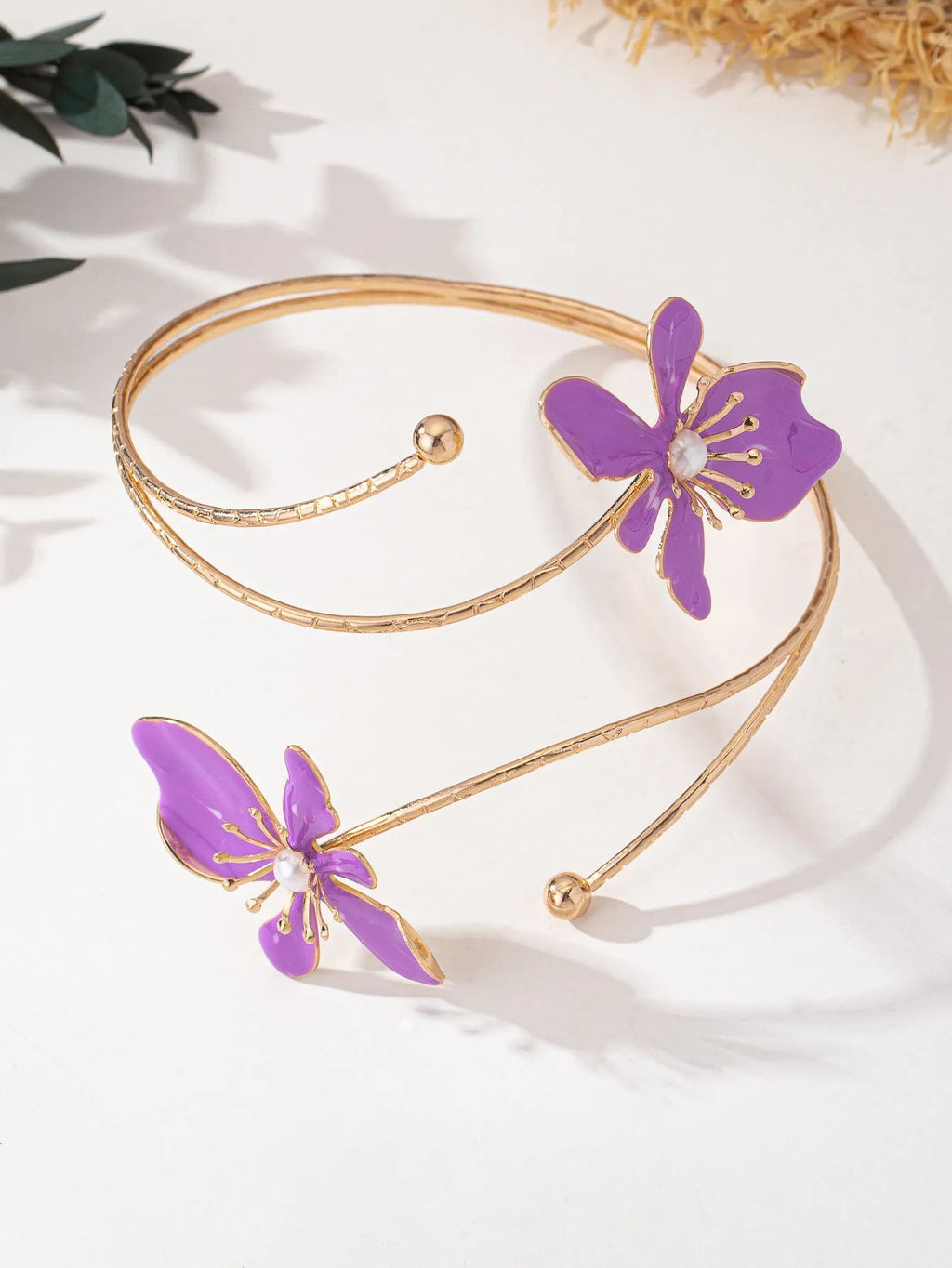 Close-up of a geometric hollow pattern alloy armband bracelet in pink, showing adjustable closure.