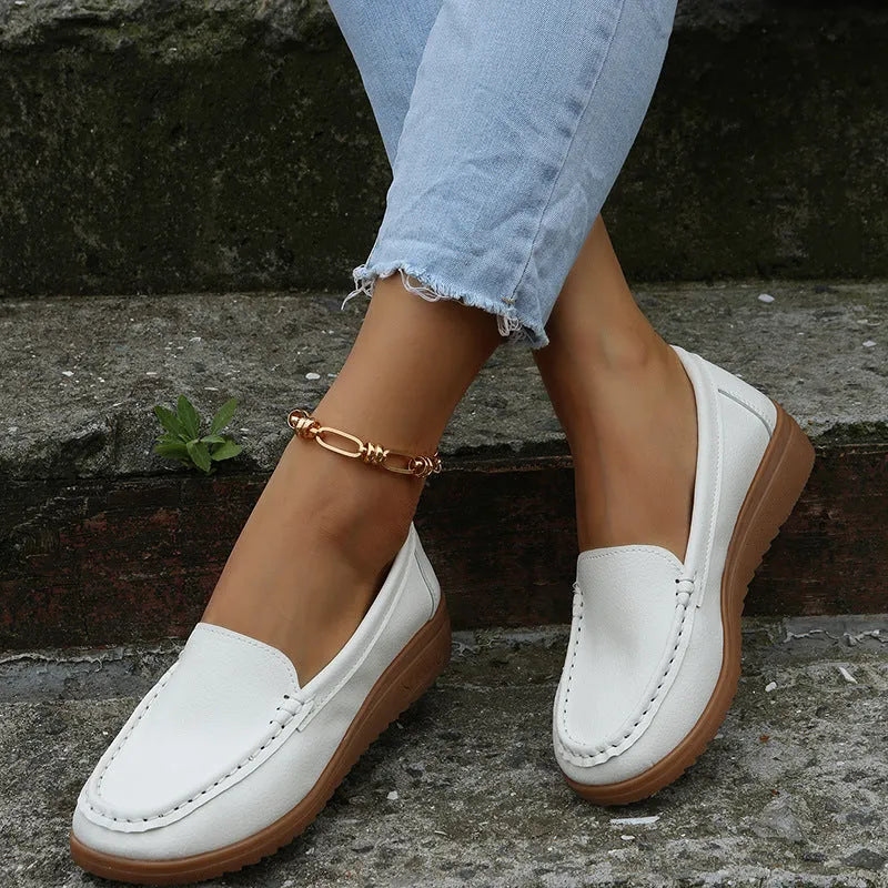 Women's black PU leather slip-on loafers with round toe and flat rubber sole