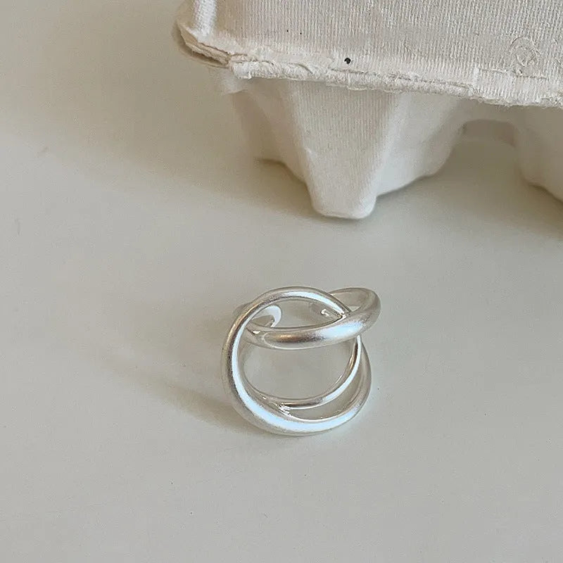 Geometric open ring with three-dimensional interlaced design in matte metal finish