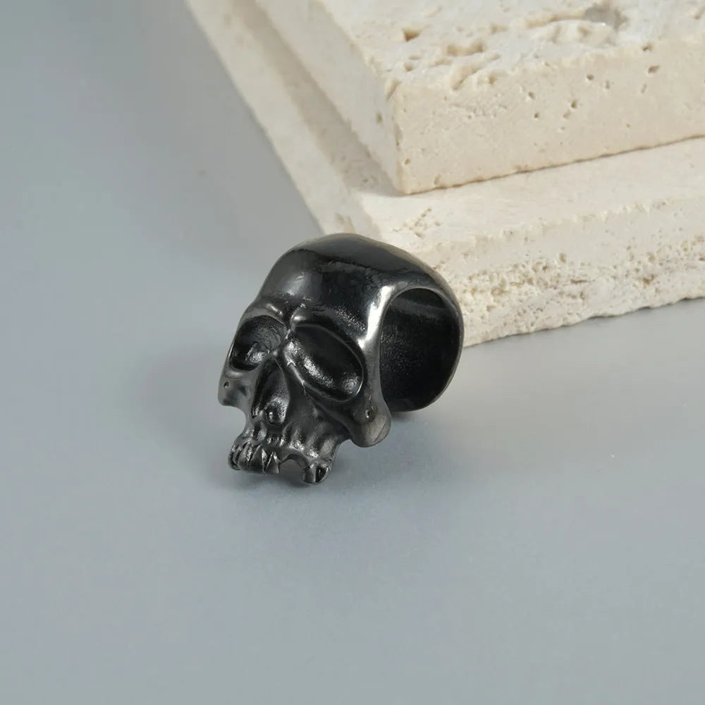 Stainless steel hollow skull Buddha earrings showing four colour finishes on geometry design