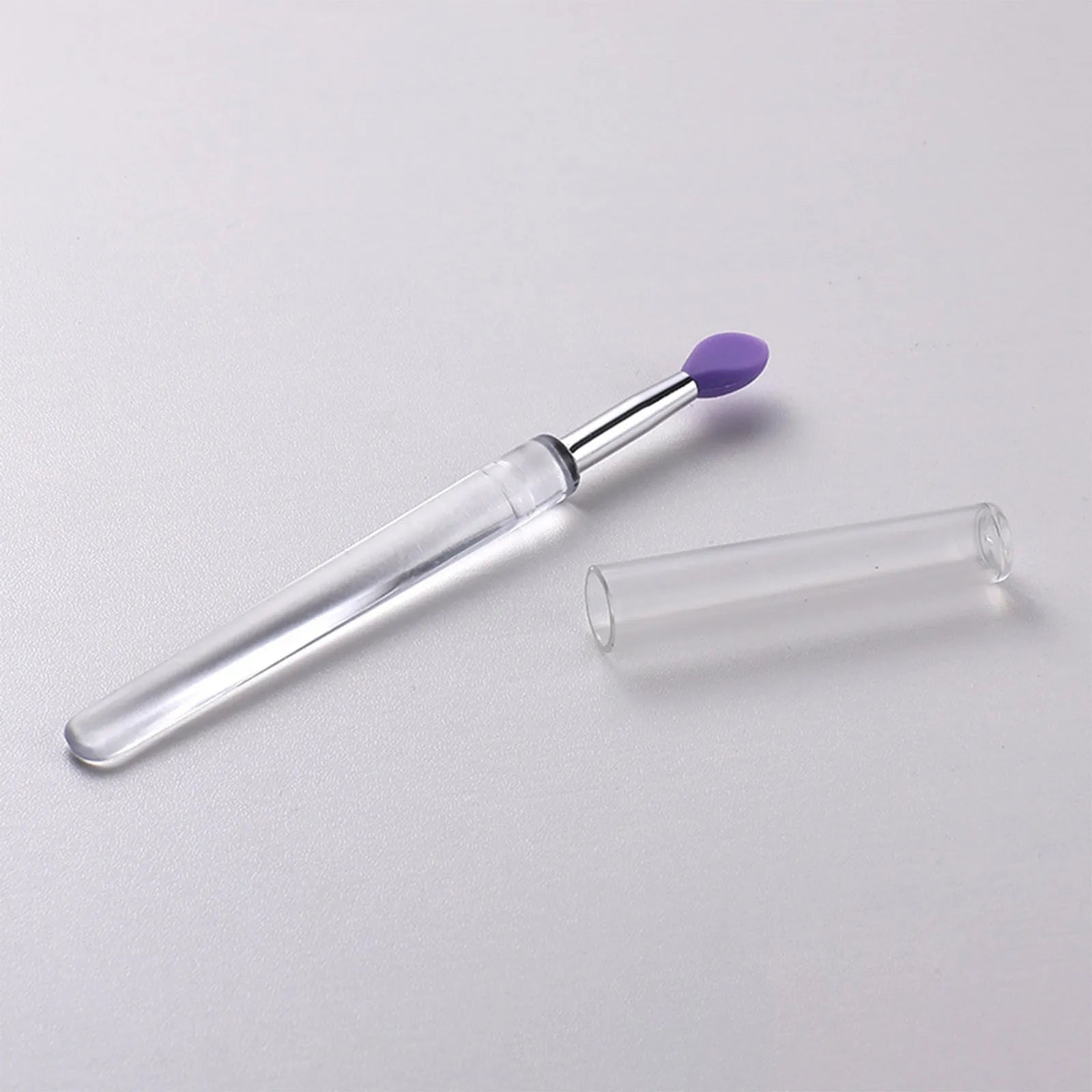 Set of reusable silicone lip brushes with protective caps in various colours.