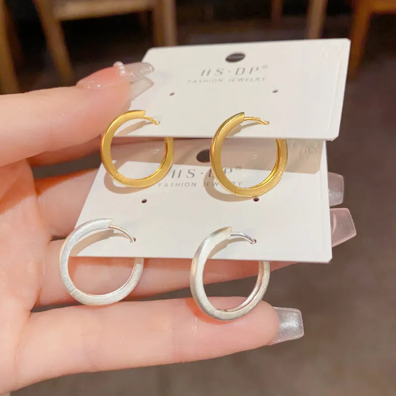 Geometric women's ear clip jewellery with simple eyelet design in gold or silver colour