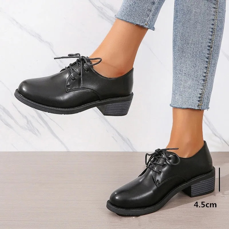 Black women's low-top work shoes with a chunky heel, PU leather upper, and rubber sole.