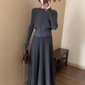 Women's dark grey knitted sweater and skirt suit set with textured 3D pattern and collage stitching.