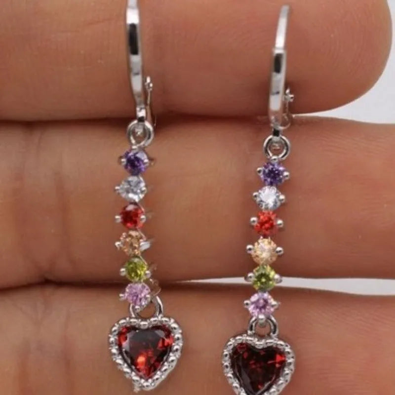 A pair of women's heart-shaped fashion earrings in a gold or silver alloy metal finish.