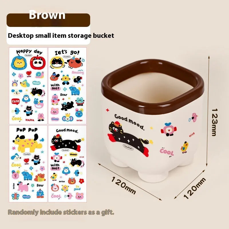 Cartoon-style red and brown plastic desktop storage box with grid compartments for organising pens and stationery.