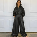 Black PU retro loose jumpsuit with puff sleeves, high waist, button front, and splicing details