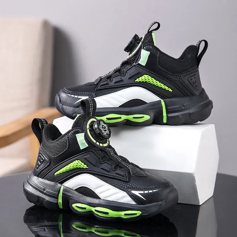 Children's waterproof leather basketball shoes with rotating buckle, black and grey colour, on natural lawn