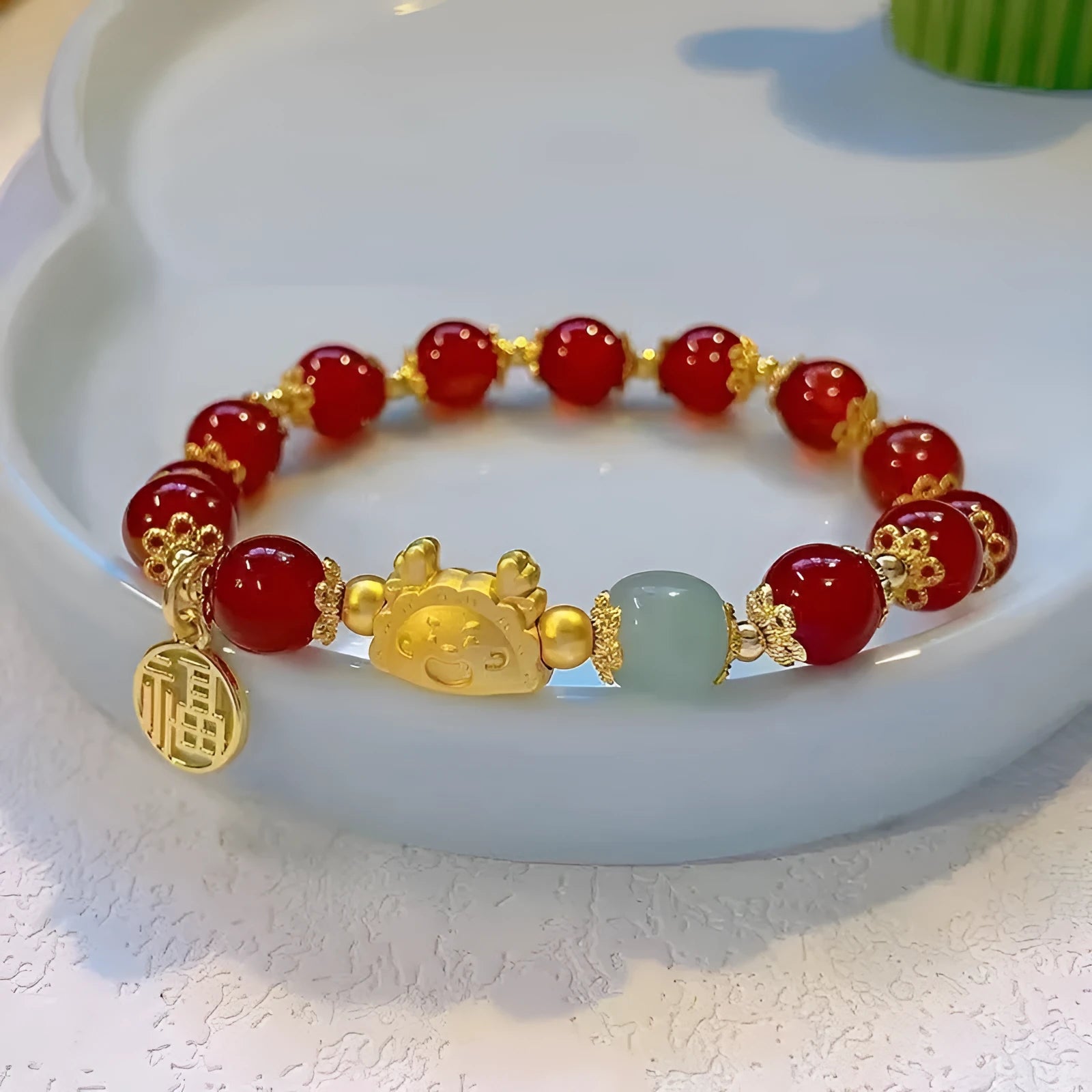 Women's floral glazed bracelet with ice crack texture and zodiac animal charm on wrist.