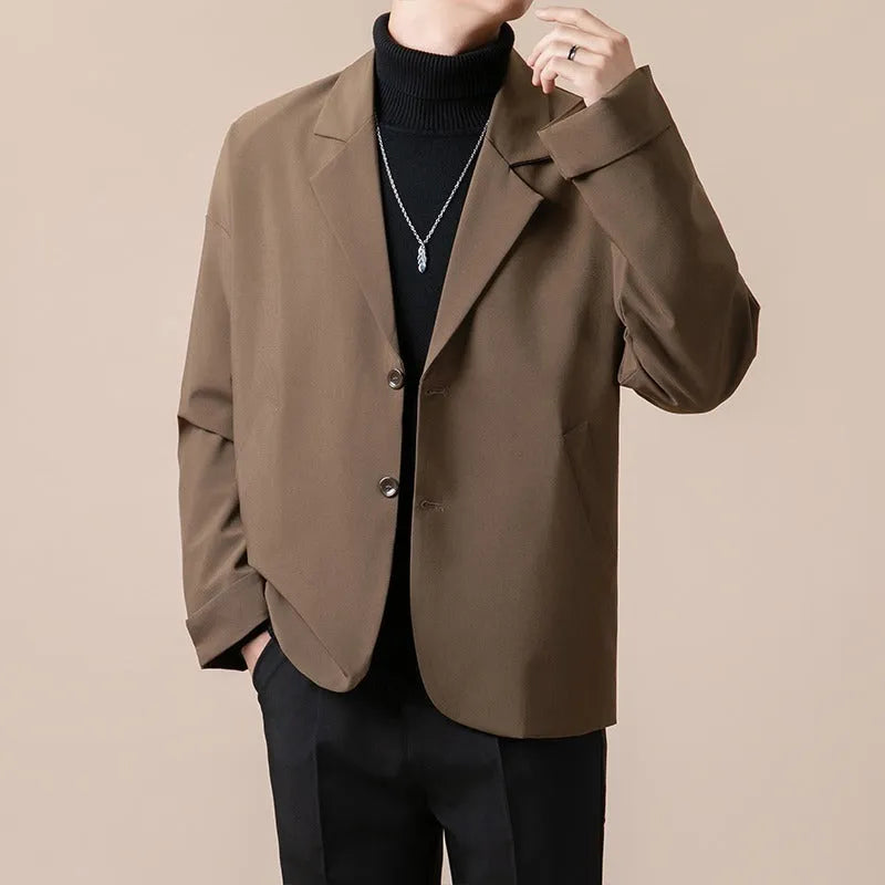 A man's loose fit suit jacket in a chemical fibre blend fabric, shown in one of four available colours.