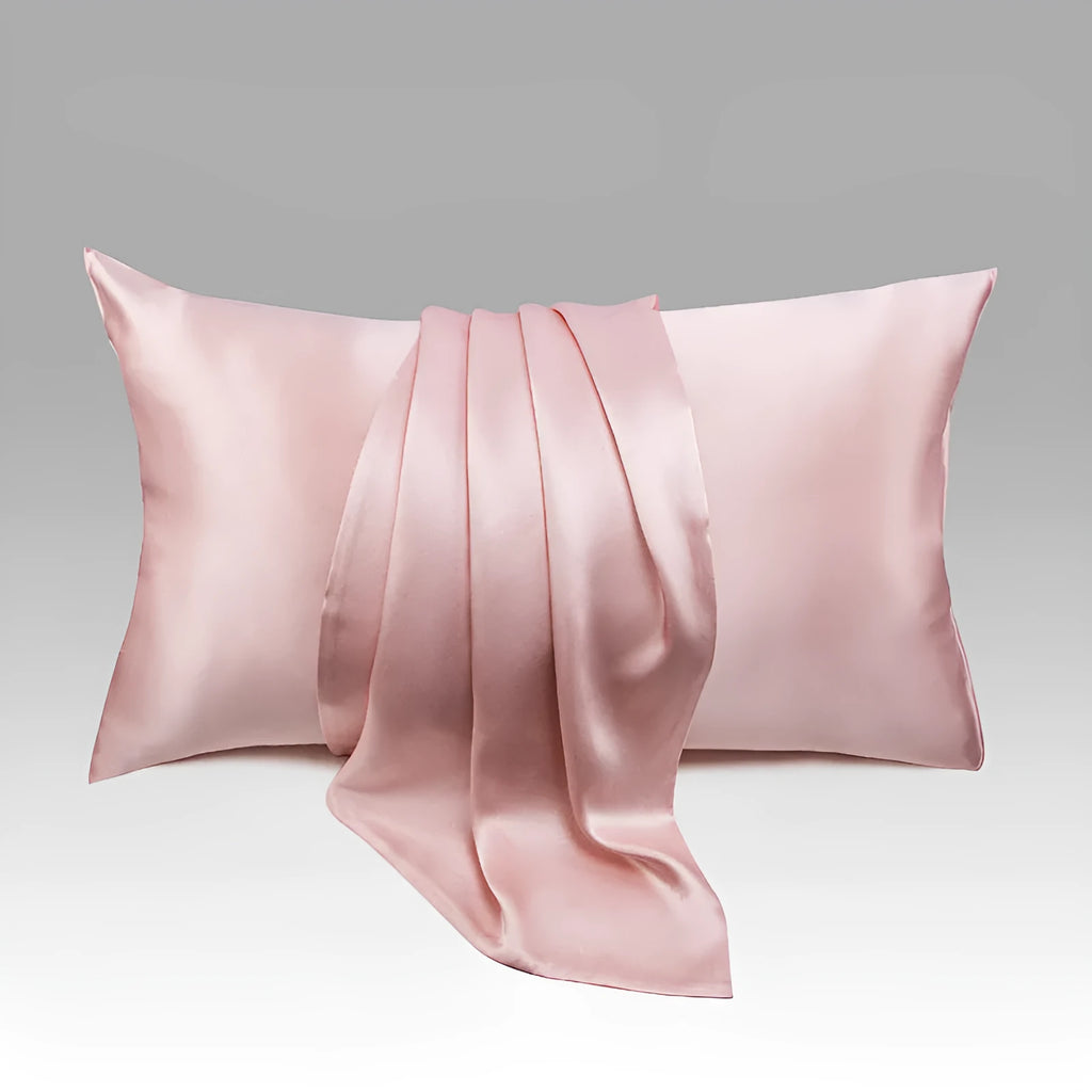Solid colour mulberry silk envelope pillowcase in dark grey on a bed.