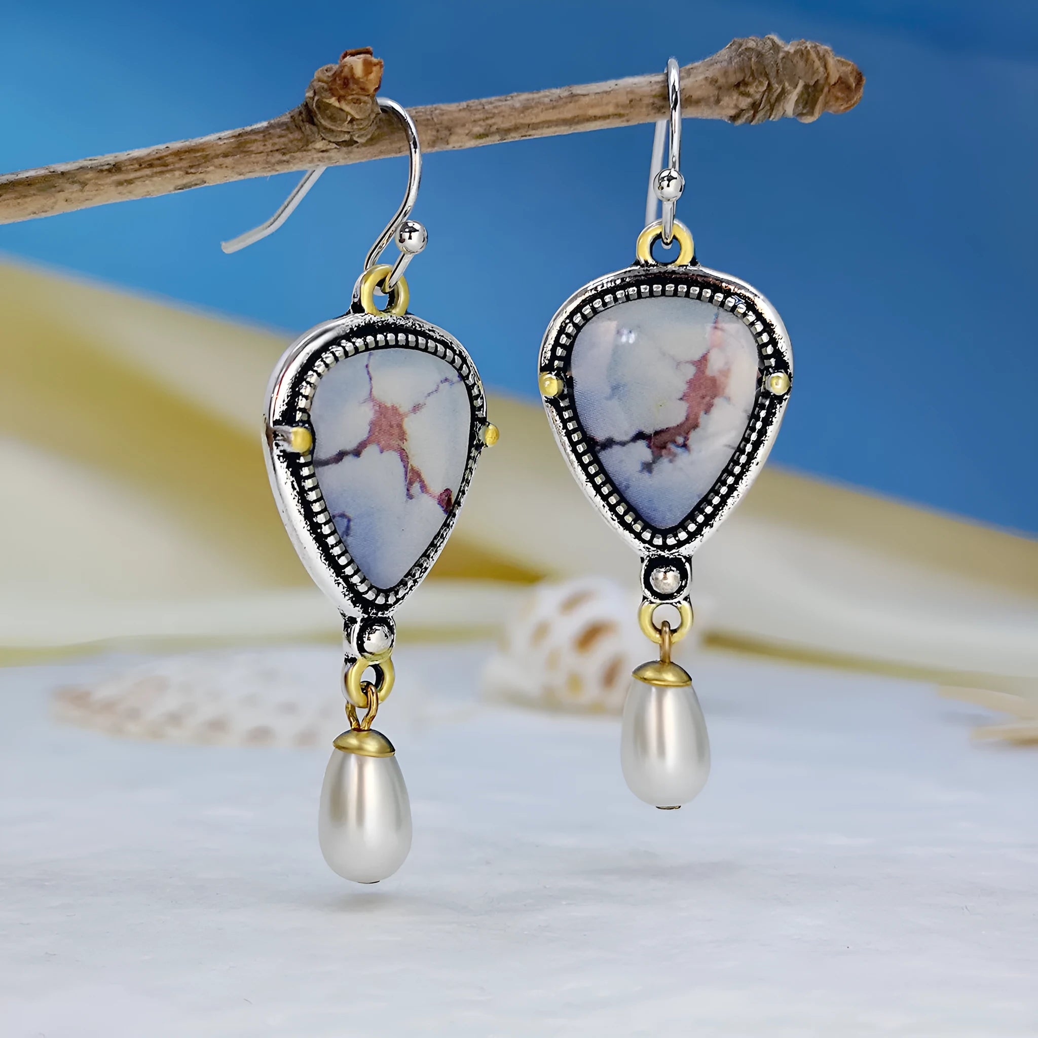 Retro blue drop earrings with geometric design featuring synthetic opal and pearl elements on electroplated metal