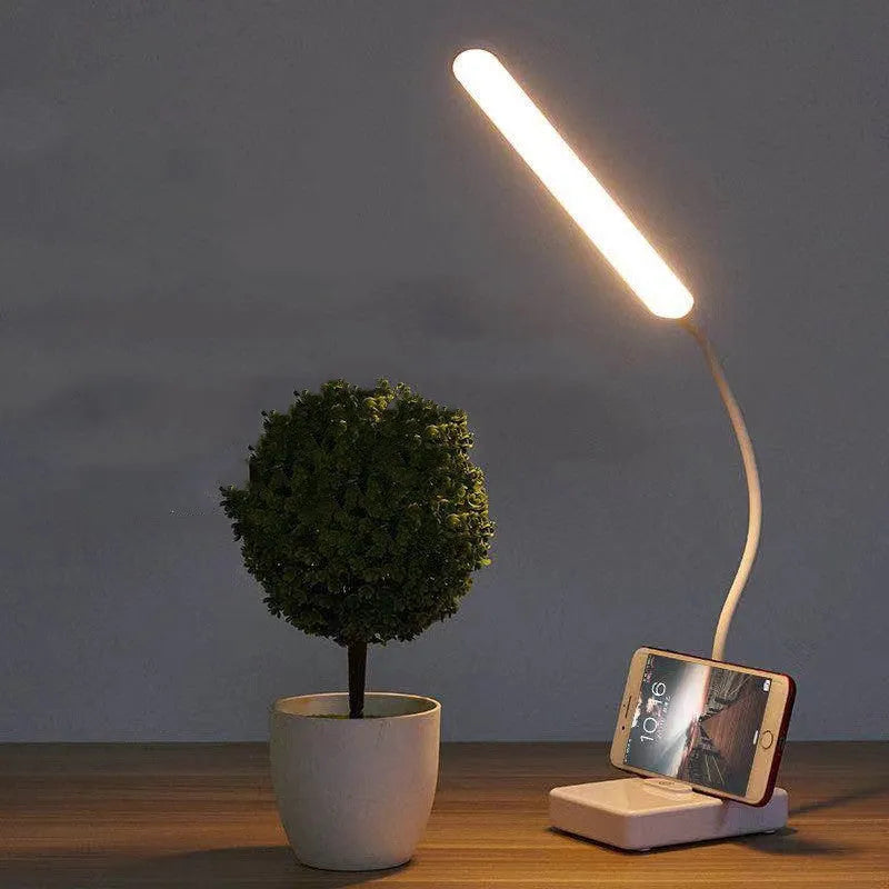 White USB charging folding LED desk lamp with touch switch and lithium battery on a desk
