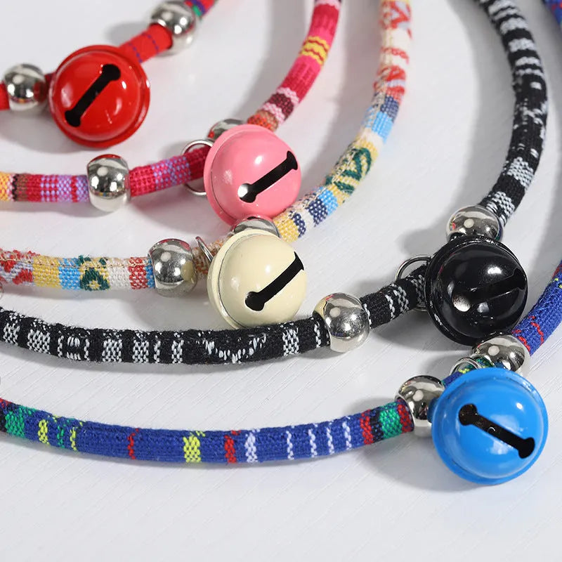 Adjustable pet collar with bell in ethnic pattern, showing colour options: black, blue, pink, red, white.