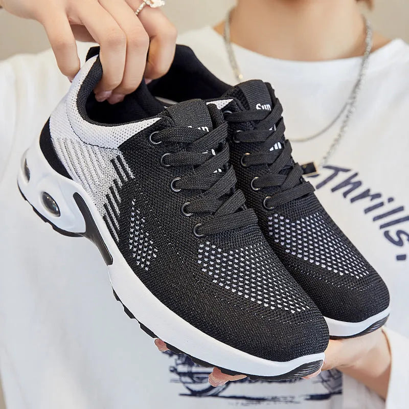 Women's Flyknit casual running shoes in a stripe pattern, showing front lace-up and round toe design.