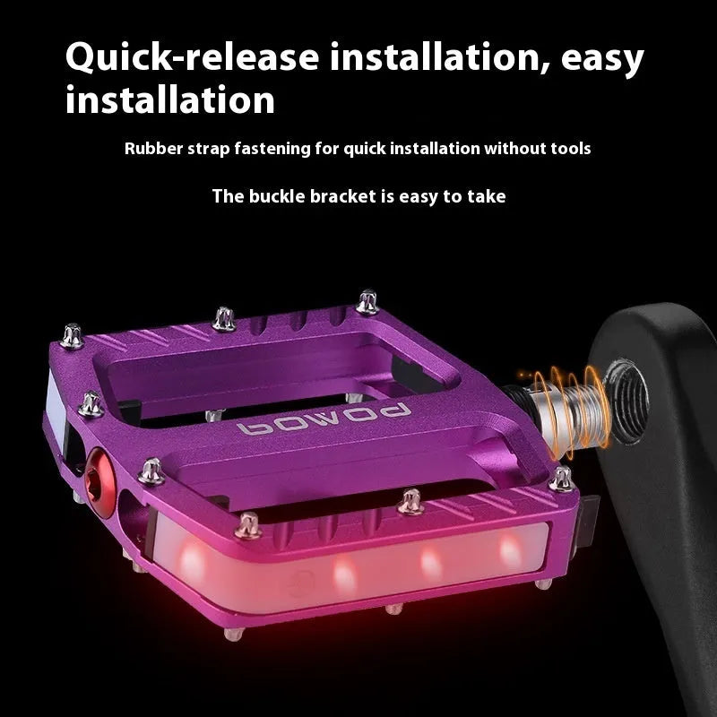 Bicycle pedals with LED lights in purple, black, titanium, red, and gold colour options