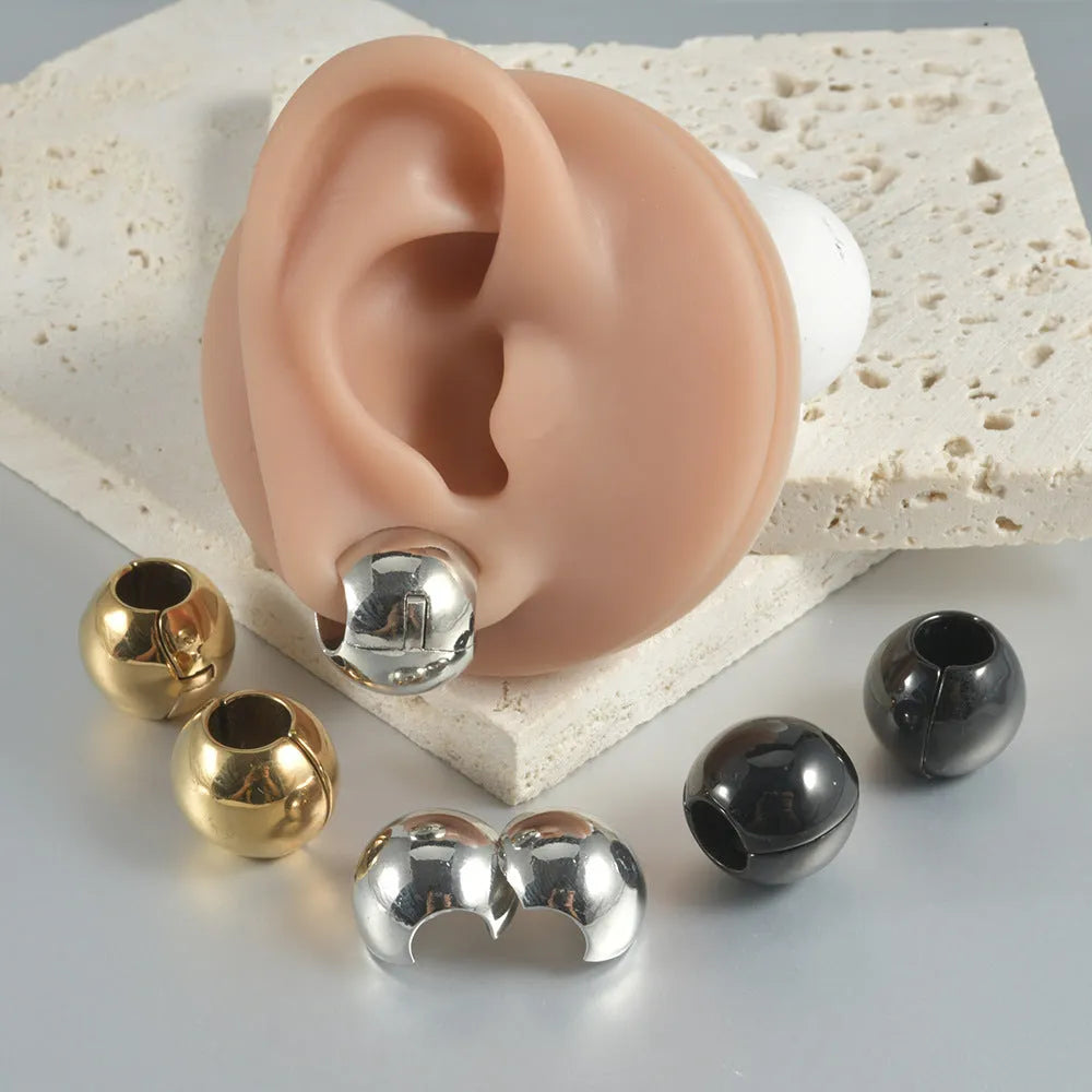 Stainless steel hollow skull Buddha earrings showing four colour finishes on geometry design