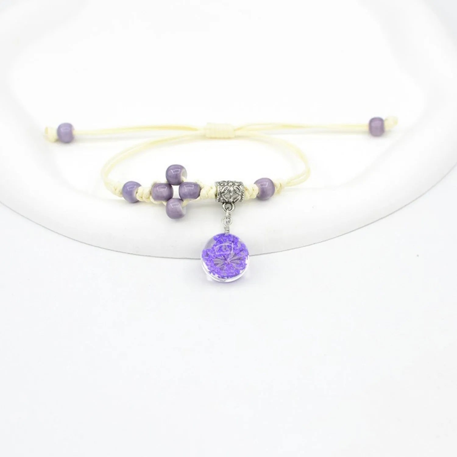 Hand-woven glass bracelet with 1.4cm beads containing real dried flowers in various colours