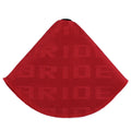 Canvas dust cover draped over a racing bucket seat in a vehicle interior.