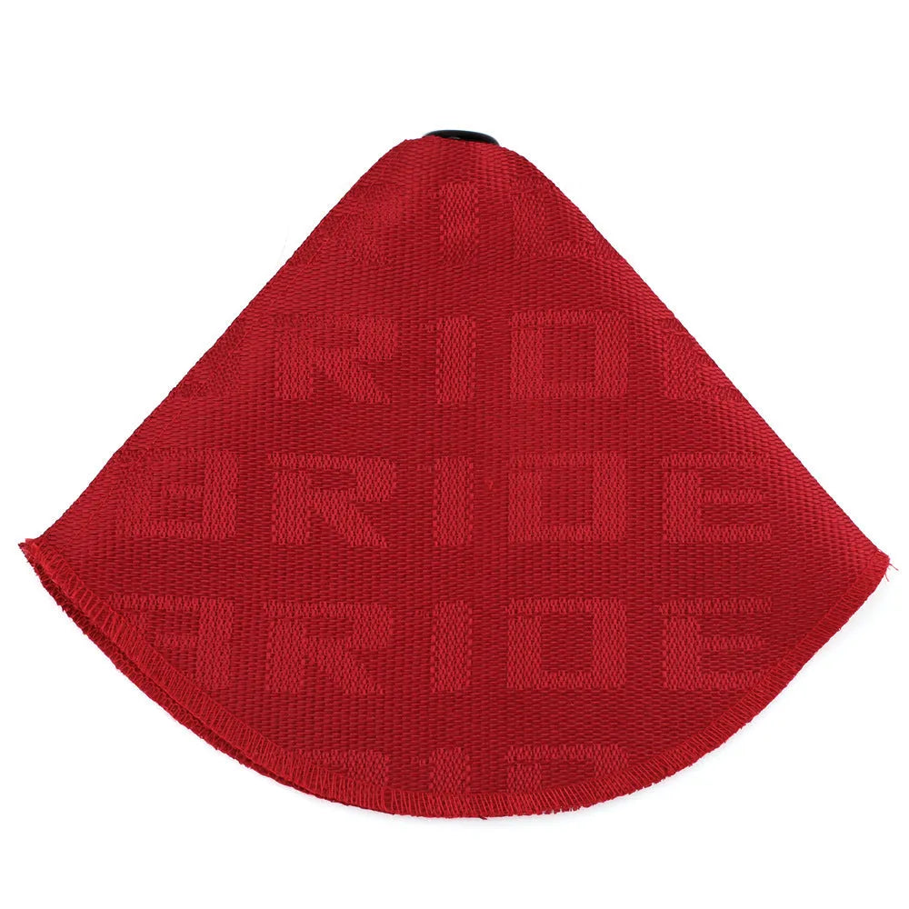 Canvas dust cover draped over a racing bucket seat in a vehicle interior.