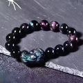 Natural obsidian eye crystal bracelet showing characteristic patterning on beads