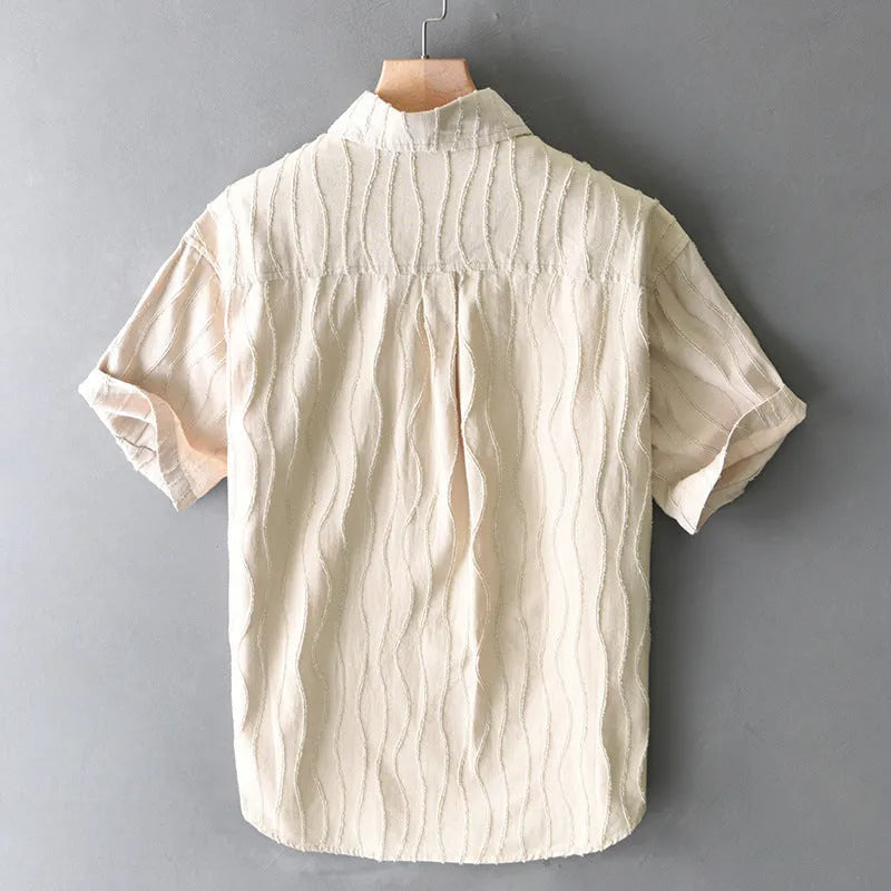 Man wearing a loose fit apricot coloured pure cotton short sleeve casual shirt