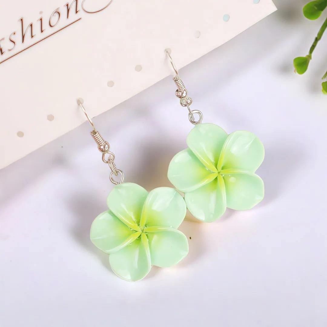 Handmade plastic resin earrings shaped like plumeria rubra flowers in a pair with multiple colour options