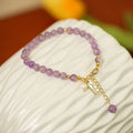 Women's natural lavender amethyst crystal bracelet showing dark and light colour options