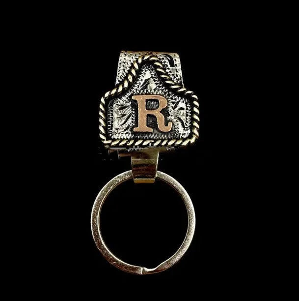 Handmade metal keychain with a cow tag charm in one of 26 available colour options.