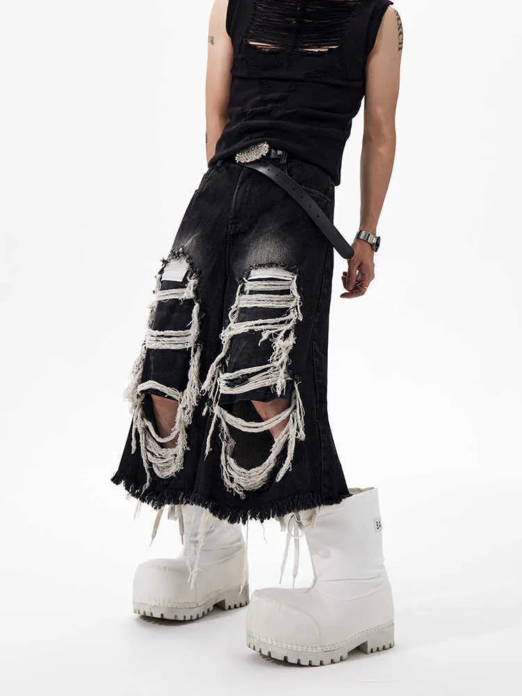 Black women's cropped wide leg jeans with distressed patches and a mid-high waist.